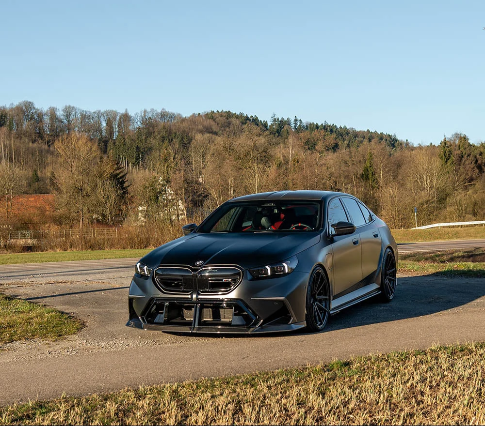 Aggressively styled matte grey BMW G90 M5 fitted with the CT Carbon Fibre Full Kit (CT Design), featuring a prominent carbon front splitter.