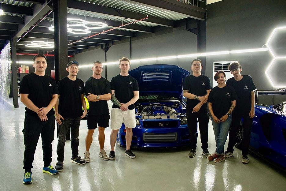 The Oryx Detailing team in the studio at Dubai Investment Park 2, standing in front of the cars
